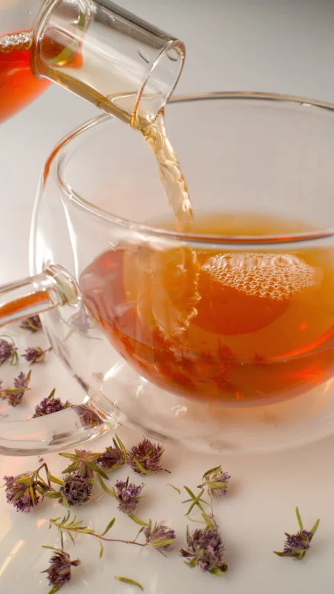 Tea is poured into a glass cup. Vertical. close-up. Stock Footage 309575380