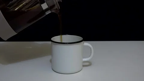 Tea is poured into an iron mug Stock Footage 159436049