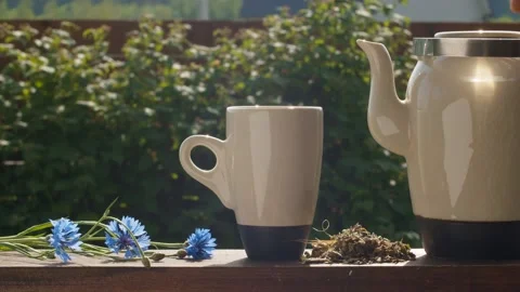Tea pouring into a cup from teapot Stock Footage 135823919