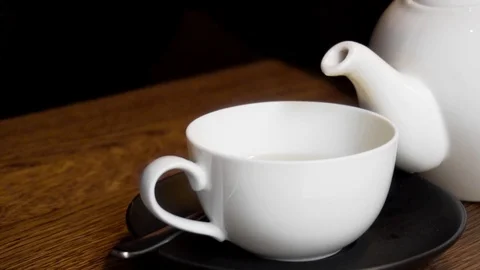 Tea pouring process from a kettle in a mug in slow motion Stock Footage 87190567