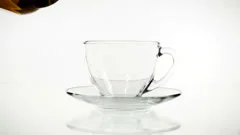 Tea Pouring. Tea Being Poured Into Glass Transparent Tea Cup. Tea