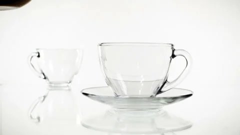 Tea pouring. Tea being poured into glass transparent tea cup. Tea time Stock Footage 88601530