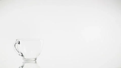 Tea pouring. Tea being poured into glass transparent tea cup. Tea time Stock Footage 88602000