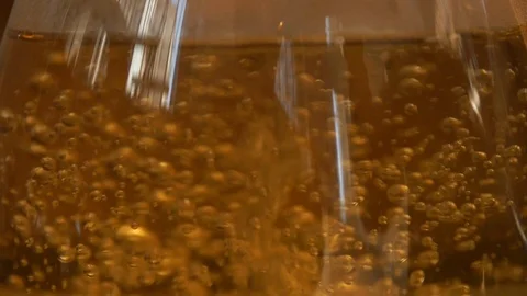 Tea pouring. Tea bubbles. Tea being poured into glass transparent tea cup Video stock 107168131