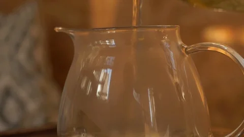Tea pouring. Tea bubbles. Tea being poured into glass transparent tea cup Video stock 107168139