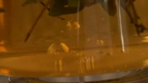 Tea pouring. Tea bubbles. Tea being poured into glass transparent tea cup Video stock 107168141