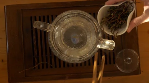 Tea pouring. Tea bubbles. Tea being poured into glass transparent tea cup Video stock 107168176