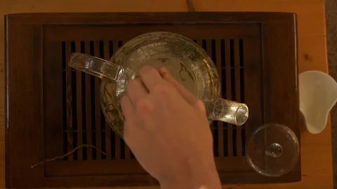 Tea pouring. Tea bubbles. Tea being poured into glass transparent tea cup Video stock 107168199