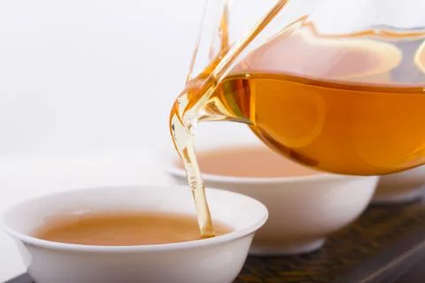 Tea pouring into tea cup Stock Photos