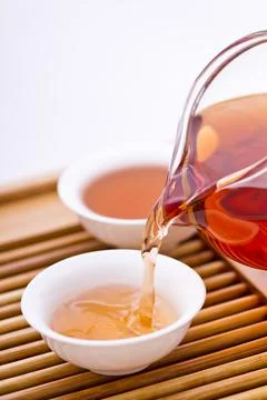 Tea pouring into tea cup Stock Photos