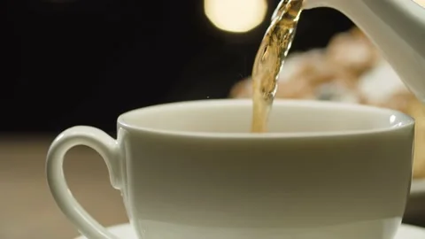 Tea pouring into a white cup Stock Footage 140404123