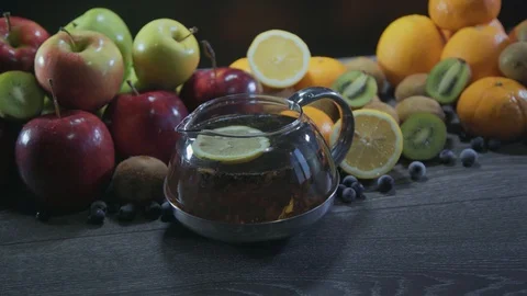 Tea pours on the table with fruit Stock Footage 126608392