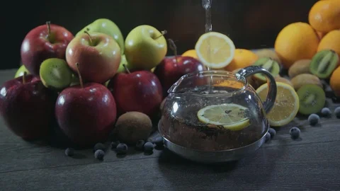 Tea pours on the table with fruit Stock Footage 126608397