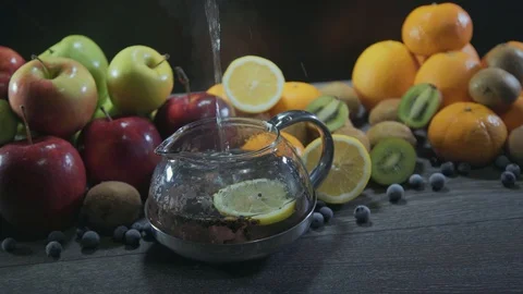 Tea pours on the table with fruit Stock Footage 126608399