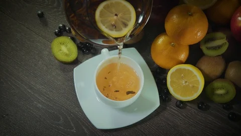 Tea pours on the table with fruit 스톡 동영상 126608401