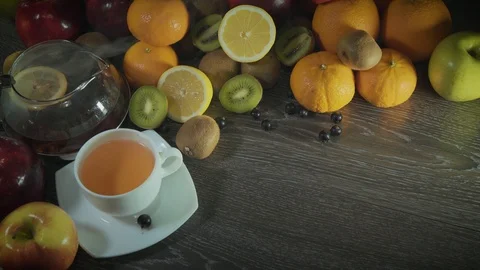 Tea pours on the table with fruit Stock Footage 126608417