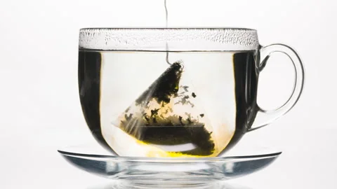 Tea Pyramid Sinks into the Cup 4K Stock Footage 196835129