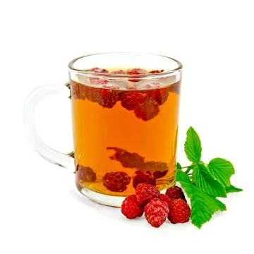 Tea with raspberry and leaf in glass mug Stock Photos