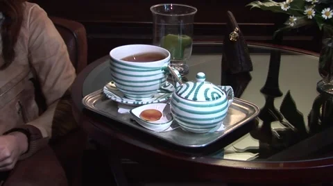 Tea is served on a glass table. Stock Footage 42866498