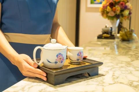 Tea set in the hands of the massager Stock Photos