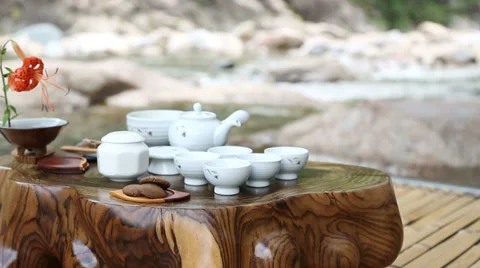 Tea Set by the Stream: A Serene Setting Stock Footage 36266141