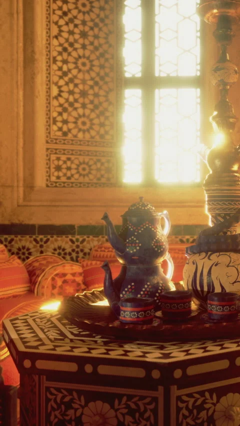 Tea set on a table in a room with patterned walls and warm light in the evening Stock Footage 331769584