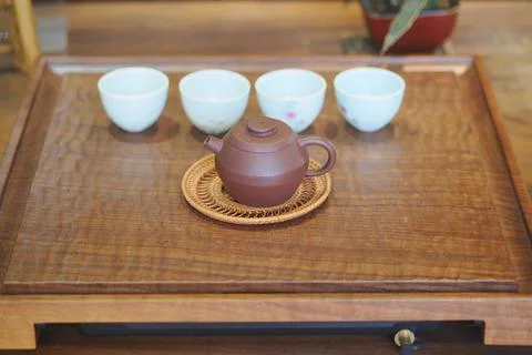 Tea setup on a wooden table with cups and teapot Stock Photos