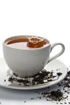 Tea splash in white cup isolated Stock Photos