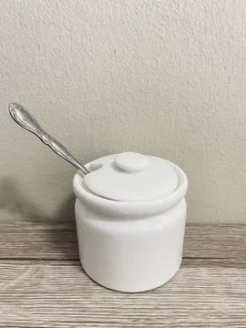 A tea spoon of salt on the table Stock Photos