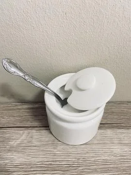 A tea spoon of salt on the table Stock Photos