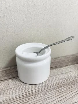 A tea spoon of salt on the table Stock Photos