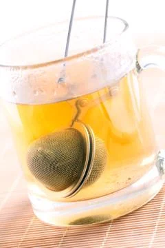 Tea strainer in cup Stock Photos