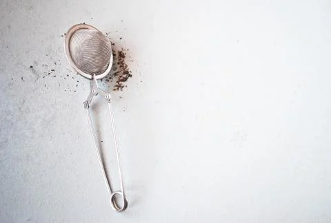 Tea strainer with dry black tea Stock Photos
