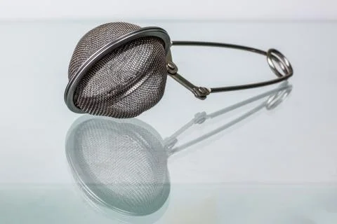 Tea strainer on glass surface Stock Photos