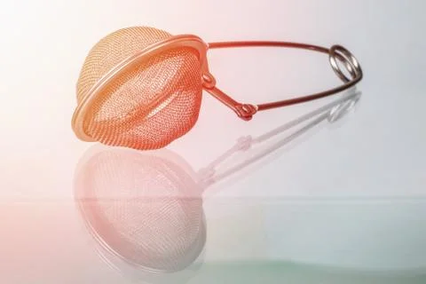 Tea strainer on glass surface Stock Photos