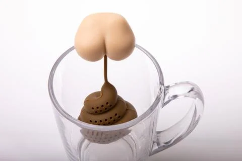 Tea strainer in the shape of a pooping bottom, a joke for guests, isolated Stock Photos