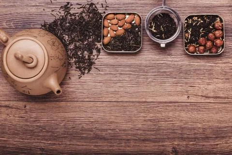 Tea strainer with tea on a wooden surface. Green and black tea Top view wit.. Stock Photos
