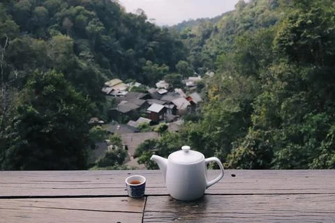Tea teapot cup table mountain village forest view, calm morning drink on wo.. Stock Photos