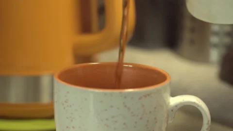 Tea from the teapot is poured into a mug. Close-up. Slow motion Stock Footage 146572603