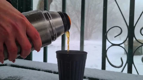 Tea from a thermos in winter during a snowfall Stock Footage 234813005