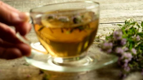 Tea with thyme in a transparent cup. Selective focus. Stock Footage 155880811