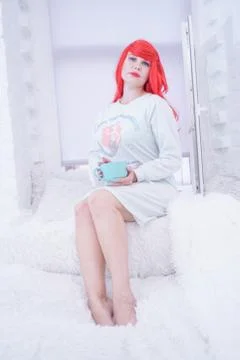 Tea time. Beautiful plus size woman holding ceramic cup of tea or coffee and Foto stock