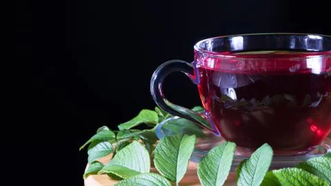 Tea time: cup of tea. Creative layout made of cup of hibiscus tea and tea lea Stock Photos