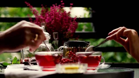 Tea time: hands mixing a cup of tea on the balcony, 120fps 스톡 동영상 118832731