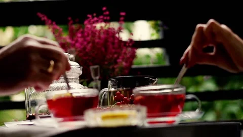 Tea time: hands mixing a cup of tea on the balcony, 120fps Stock Footage 118832999