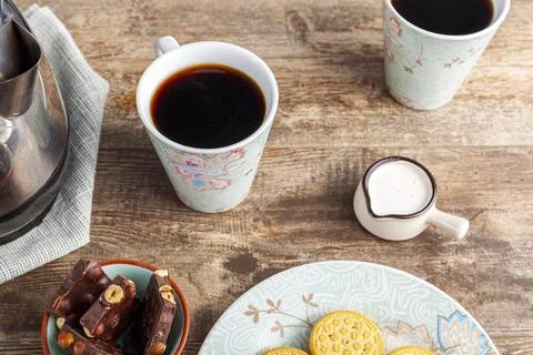 A tea time or coffee time concept with sandwich cookies, bars of chocolate ae Stock Photos