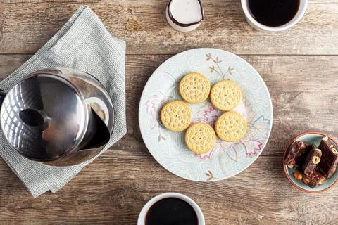 A tea time or coffee time concept with sandwich cookies, bars of chocolate ae Stock Photos