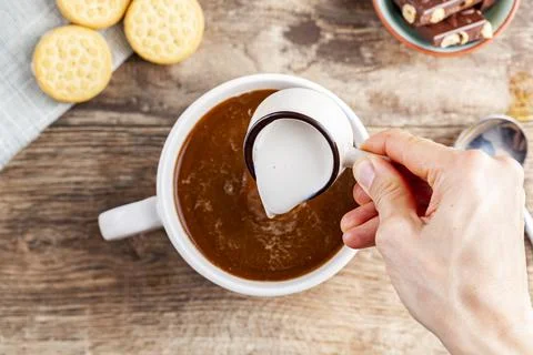 A tea time or coffee time concept with sandwich cookies, bars of chocolate ae Stock Photos