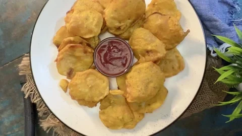 Tea time snack pakora  made with potato served  in a white ceramic plate. Stock Footage 287302752