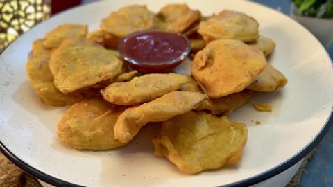 Tea time snack pakora  made with potato served  in a white ceramic plate. Stock Footage 287307460